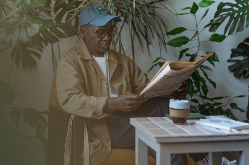 An older man relaxing and reading at home